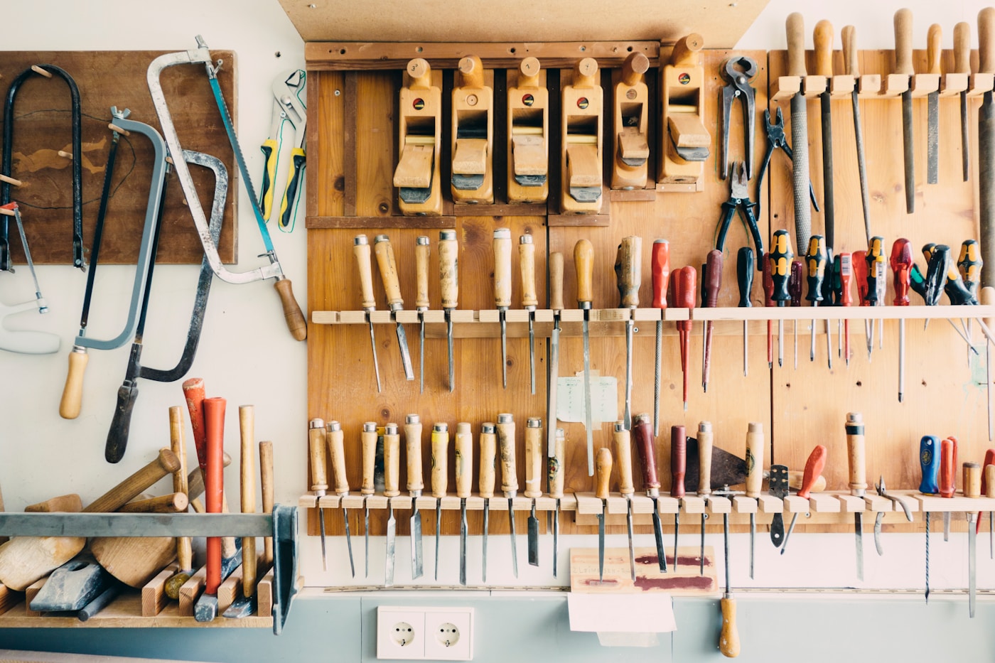 A workshop rack of assorted hand tools, each shaped for one job, a metaphor for the specialized units on an Apple M-series die
