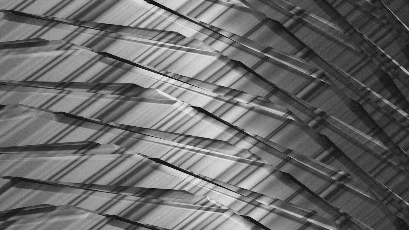 Chrome geometric shapes intersecting in light and shadow, a metaphor for constraints and tensor shape