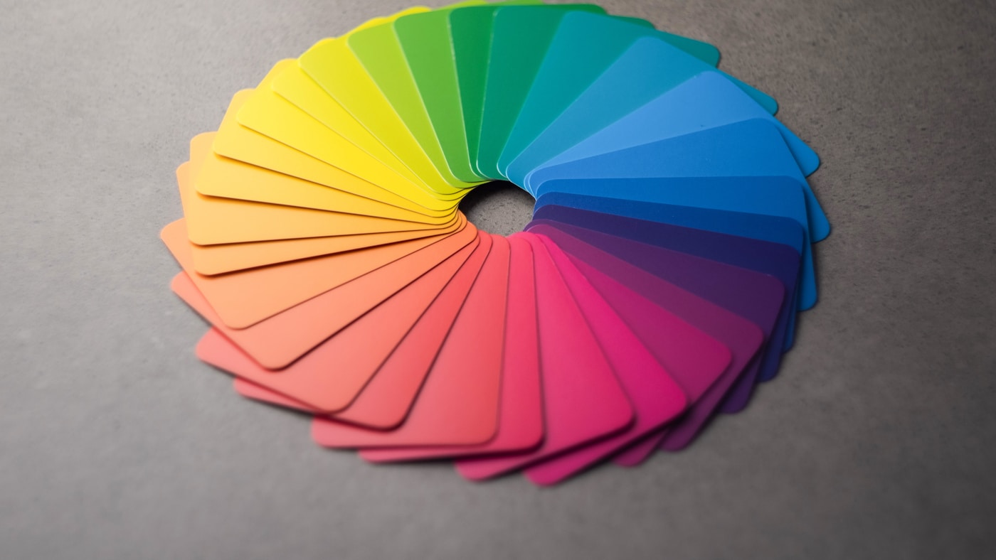 A color wheel fanned out from swatch cards, echoing the circular structure of Michael Edwards' Fragrance Wheel