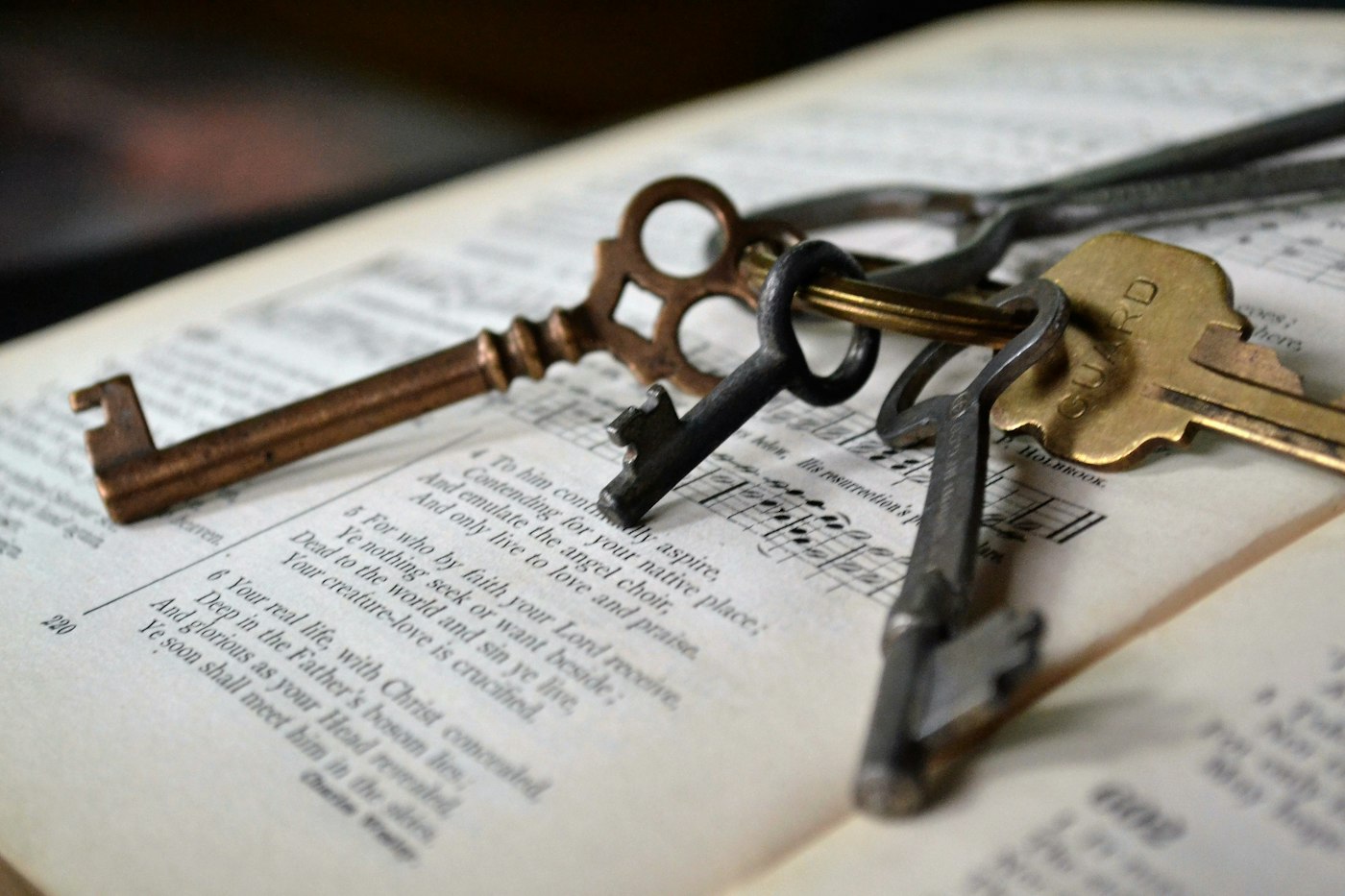 A ring of old keys lying on an open book, a metaphor for retrieval, permissions and context that a thinking model cannot produce by reasoning harder