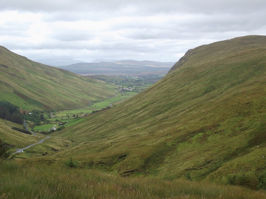 A wide green valley seen from a high ridge, a metaphor for a margin broad enough that the decision stops being close